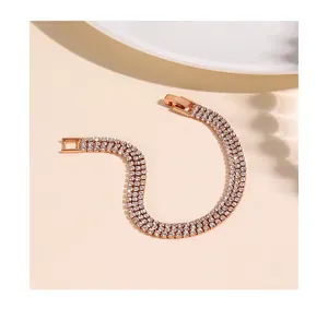 Macro shot of rose gold triple-row tennis bracelet featuring white cubic zirconia stones