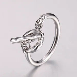 Detail of silver toggle chain ring showing a modern minimalist T-bar and link design