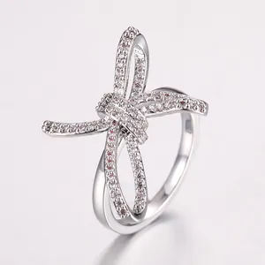 Silver bow knot ring with micro-paved white zircons in a minimalist luxury style