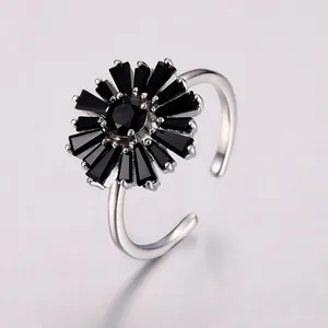 Macro detail of silver adjustable ring with sunflower design and black crystals