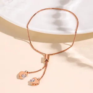 Elegant rose gold adjustable heart bracelet with zircon stones on white ceramic plate
