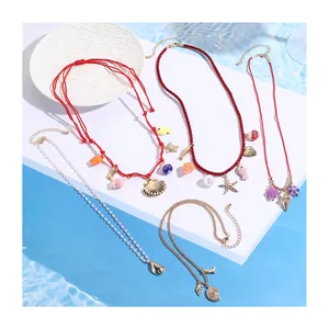 Detail view of ocean-themed necklace set featuring seahorse, starfish, and shell pendants