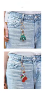 Detail of Christmas tree and stocking charms attached to a denim waistband for styling
