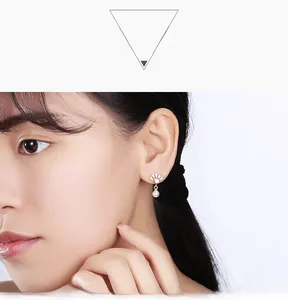 Mannequin portant d'élégantes boucles d'oreilles en or en éventail avec zircon et perle