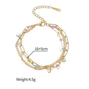 Close-up of 18K gold stainless steel layered bracelet with colorful crushed stones