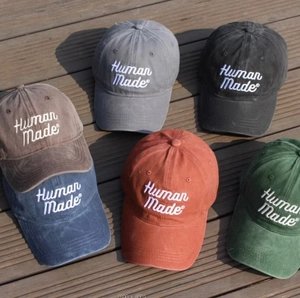 Vintage washed cotton baseball caps with embroidered script logo in various colors