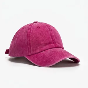 Detail of adjustable strap and vintage washed cotton texture on the rose red baseball cap