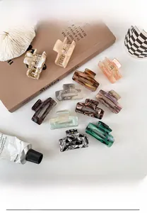 Flat lay display of colorful acetate hair claws with tortoise and marble patterns