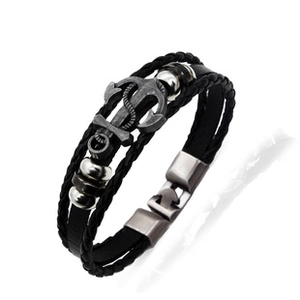 Macro detail of men's leather anchor bracelet with vintage silver nautical charms