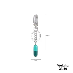 Detailed view of bicolor resin capsule keychain with measurements 11.7cm and 21.8g weight
