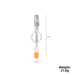 Detailed size view of the resin capsule keychain showing dimensions 11.7cm and 21.8g weight