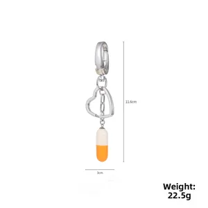 Detailed view of bicolor resin capsule keychain with measurements 11.6cm length and 22.5g weight