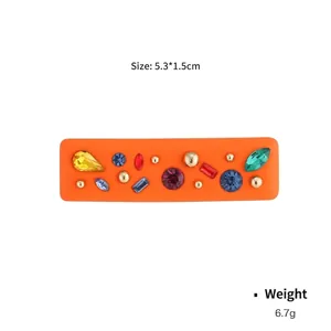 Rectangular orange hair clip with colorful faceted rhinestones and golden metal beads