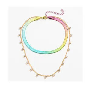 Detail of rainbow gradient herringbone chain with gold layer and square crystal charms