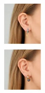 Detail showing teal rhinestone hoop and gold drop earring with purple bead on ear