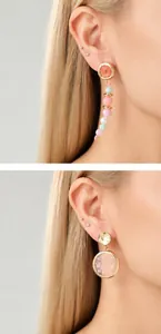 Detail of beaded tassel earring and round resin stud with pink dried flower petals