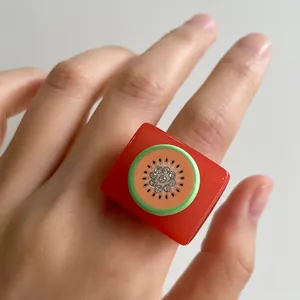 Chic red resin square ring featuring a creative kiwi fruit slice design with rhinestones
