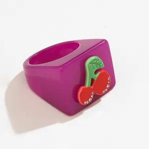 Y2K style chunky resin ring in magenta purple with 3D cherry and rhinestone accents