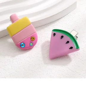 Detailed close-up of cute resin watermelon and ice cream hair clips with metal duckbill grips