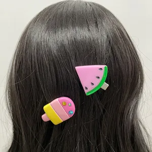 Cute resin watermelon and popsicle hair clips set with rhinestones on dark hair