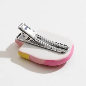 Cute watermelon resin hair clip showing the back metal duckbill clip on white background