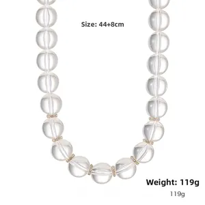 Detalle de collar de cuentas acrílicas transparentes con espaciadores dorados, 44+8cm y 119g