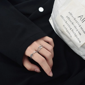 Detail shot of vintage S925 sterling silver twisted rings with black cross and beads