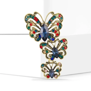 Macro detail of vintage butterfly brooch with colorful rhinestones on hollow wings