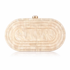 Macro detail of cream white marble texture and golden clasp on oval evening clutch bag
