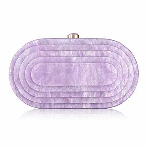 Detail of purple marble acrylic evening clutch with gold gemstone clasp and layered design