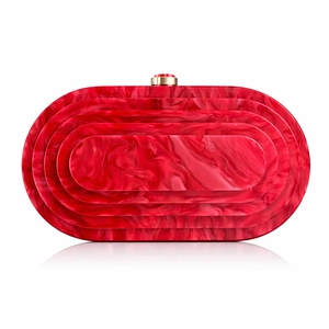 Detail view of red marble acrylic evening bag with gold circular clasp and tiered design