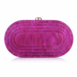 Detail of fuchsia acrylic clutch bag with marble texture and gold metal clasp