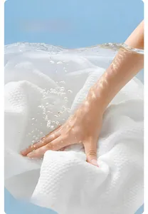 Detail showing the white pearl texture of the thick disposable compressed bath towel
