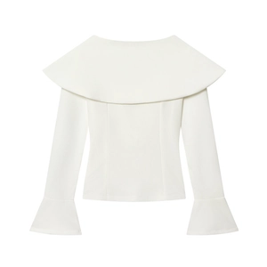 Detailed close-up of a white elegant blouse featuring a large collar and layered flare cuffs