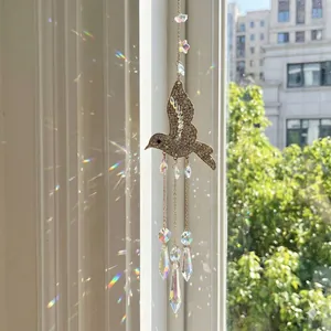 Sparkling hummingbird crystal suncatcher pendant reflecting rainbow light on a bright window