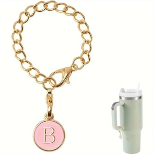 Pink enamel letter B charm with gold chain and lobster clasp on travel mug handle