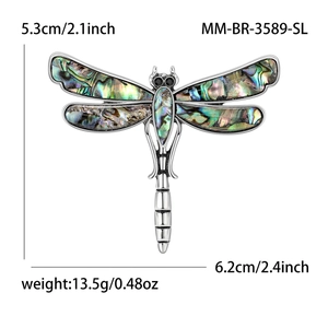 Vintage dragonfly brooch with emerald shell wings on a silver-tone metal base