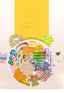 Macro shot of waterproof inspirational quote stickers for DIY decoration on a white plate