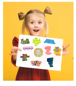 Girl holding display card with various colorful motivational quote stickers for DIY decor