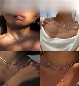 Detail view showing layered hiphop style gold and silver tennis chains with cross pendants