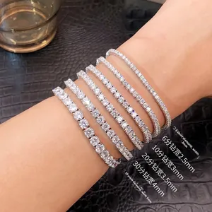 Detail view of various tennis bracelet widths from 2mm to 5mm on a model's wrist