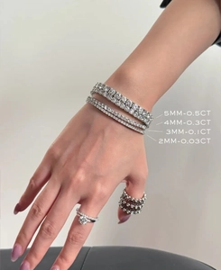 Detail view of hip hop tennis bracelets in four sizes from 2mm to 5mm on a model wrist
