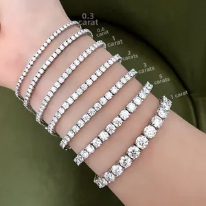Close-up showing a range of tennis bracelet sizes from 3pt to 1ct on green velvet