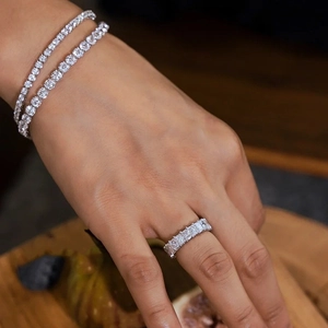 Close-up detail of silver tennis bracelets and ring with shimmering pave-set diamonds