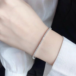 Close-up of sparkling silver tennis bracelet with rhinestones worn on a female wrist