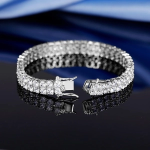 Close-up of sparkling double-row tennis bracelet with secure double clasp on silk