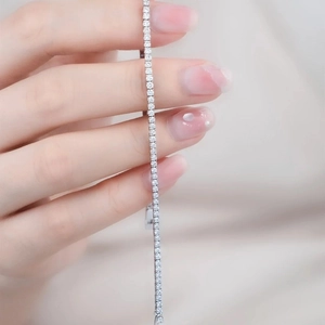Close-up of sparkling tennis bracelet with round cubic zirconia on a model's wrist