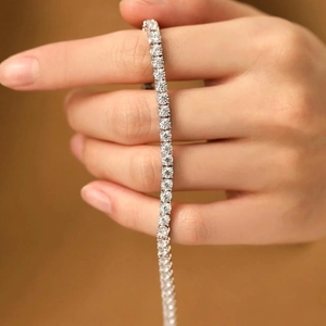 Detailed macro view of sparkling tennis bracelet with round cut stones in claw setting