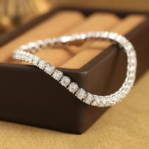 Macro shot of a sparkling hiphop tennis bracelet with round-cut stones in four-prong setting
