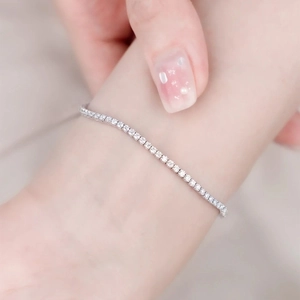 Classic silver tennis bracelet with shimmering round-cut zircon stones on female wrist